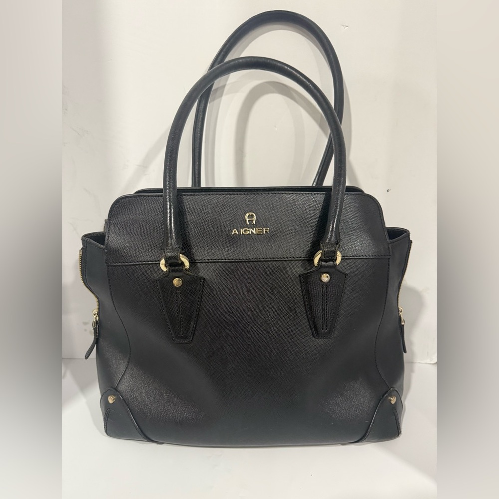 This is an Etienne Aigner black leather satchel.